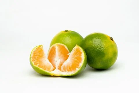 Opened green tangerine on the table Stock Photos