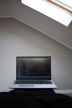 Opened laptop with code on the screen on the table 스톡 사진