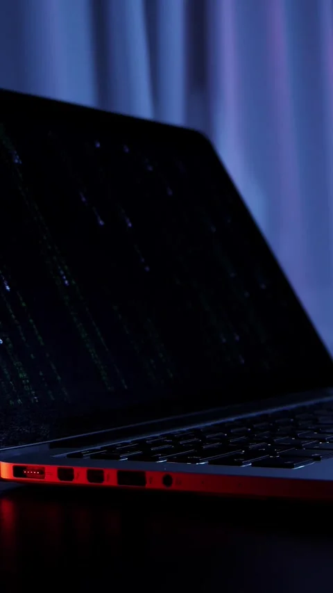 Opened laptop computer in dark room with red lights, close up. Vertical video Stock Footage 318162534