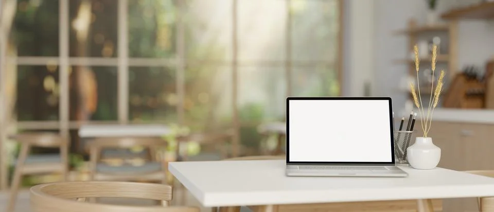 An opened laptop computer on a table in cozy contemporary coffee shop or re.. Stock Illustration