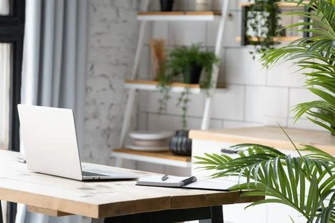 Opened laptop notebook on wooden table with mobile phone and notepad at the home Stock Photos