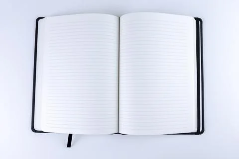 Opened lined blank paper book on white background. Mock up or copy space. Empty Stock Photos