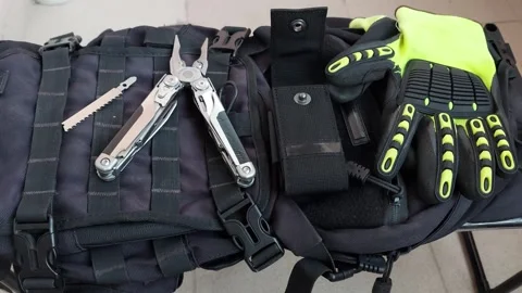Opened multitool with heavy duty pliers on black tactical background, top view Stock Footage 346248319