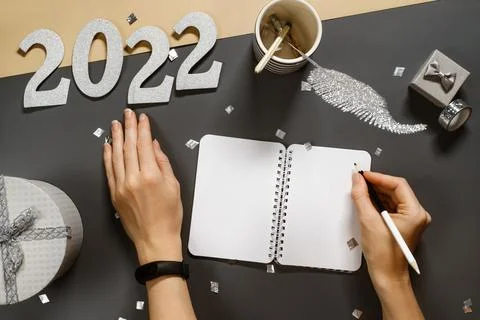 Opened note book for New Year lists on dark desk with gift Stock Photos