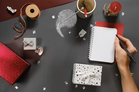 Opened note book for New Year lists on dark desk with gift Stock Photos
