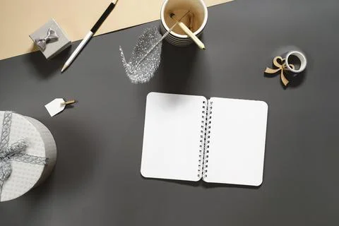 Opened note book for New Year lists on dark desk with gift Stock Photos