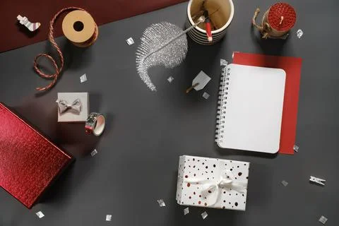 Opened note book for New Year lists on dark desk with gift Stock Photos