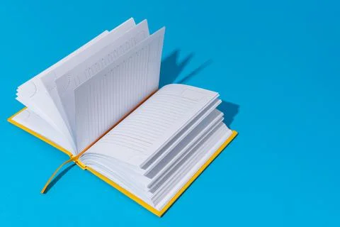 Opened notebook on blue background with copy space Stock Photos
