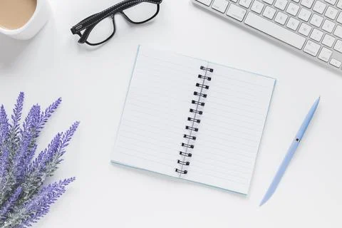 Opened notebook near lavender keyboard glasses desk . High quality and Stock Photos