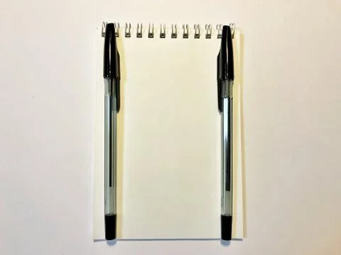 Opened notebook paper with black pen on white desk, copy space Foto stock