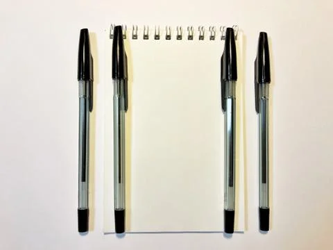 Opened notebook paper with black pen on white desk, copy space Stock Photos