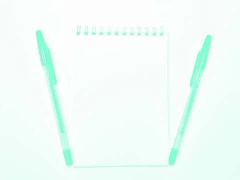 Opened notebook paper with pen on white desk, copy space. Aqua Menthe Stock Photos