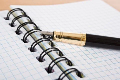 Opened notebook with pen Stock Photos