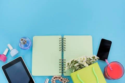 The opened notebook for records lies on the surface of the cocktail pink glas Stock Photos