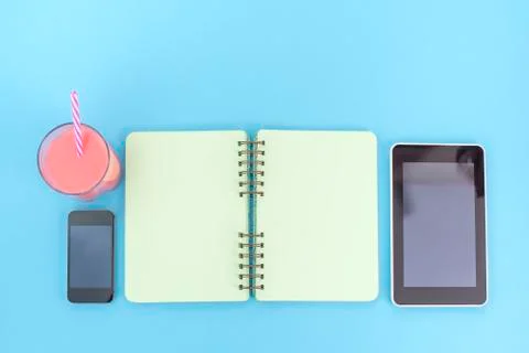 The opened notebook for records lies on the surface of the cocktail pink glas Stock Photos
