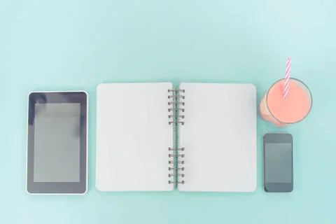 The opened notebook for records lies on the surface of the cocktail pink glas Stock Photos