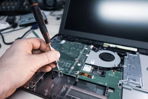 Opened notebook is repaired in a computer workshop Stock Photos