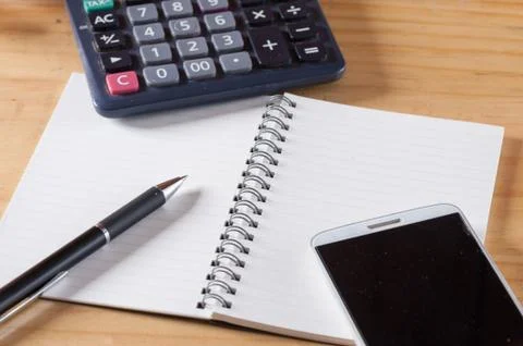 Opened notebook on wood table Stock Photos