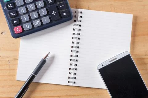 Opened notebook on wood table Stock Photos