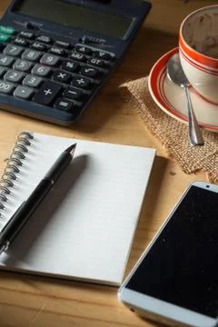 Opened notebook on wood table Stock Photos