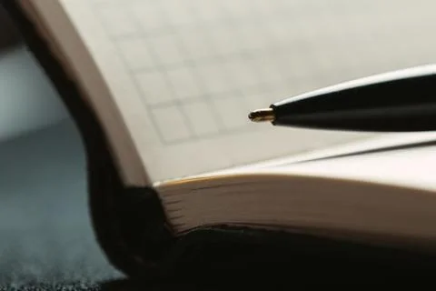 Opened notepad with automatic plastic ballpoint pen close up. Stock Photos