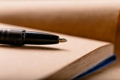 Opened notepad with automatic plastic ballpoint pen close up. Stock Photos