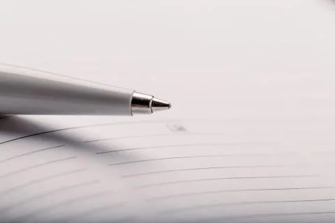 Opened notepad with automatic plastic ballpoint pen close up. Stock Photos