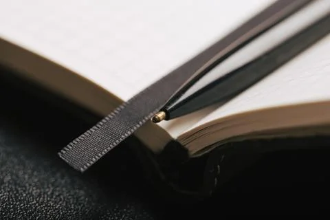 Opened notepad with automatic plastic ballpoint pen close up. Stock Photos