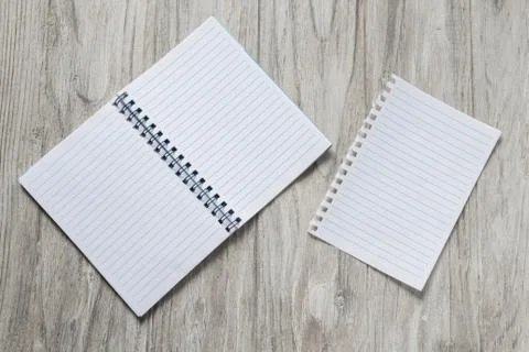 Opened notepad with a sheet of paper on wooden background Stock Photos