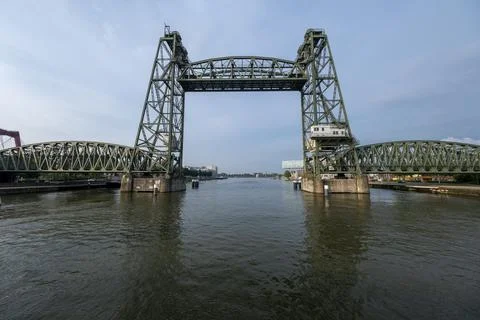 Opened olive green, steel elevator bridge over a canal on a beautiful day Stock Photos