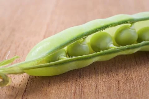 Opened pea pod Stock Photos