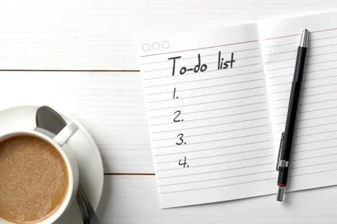 Opened personal organizer with a to do list. on white wooden background Stock Photos