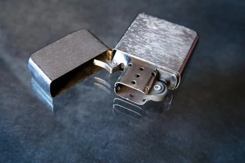 Opened petrol lighter on a dark background Stockfoto's