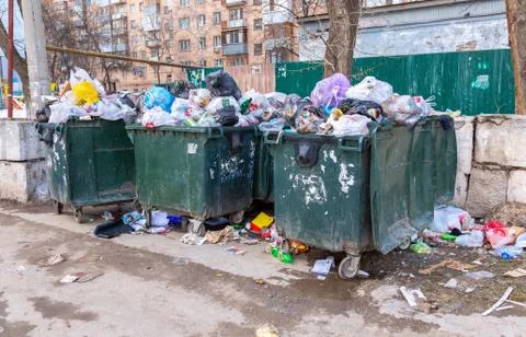 Opened plastic recycling containers with garbage and different rubbish Stock Photos