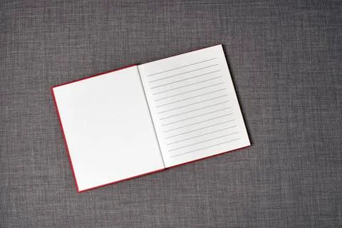 Opened red book on the sofa Stock Photos