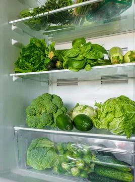 Opened refrigerator full of fresh vegetables. Stock-Fotos