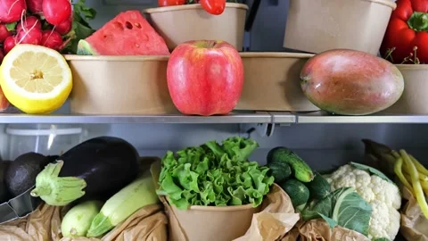 Opened refrigerator full of vegetarian healthy fruit, vegetables in zero waste b Stock Footage 196445237