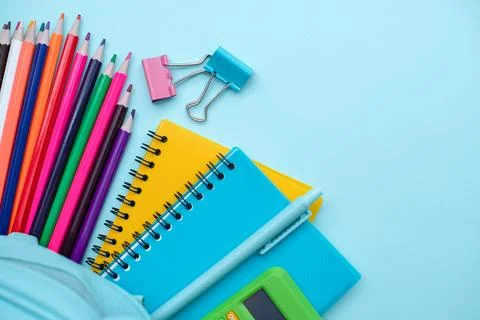 Opened School backpack with stationery on blue background. Organization of the Stock Photos