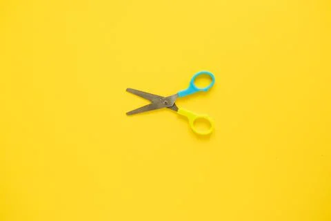 Opened scissors laid middle Stock Photos