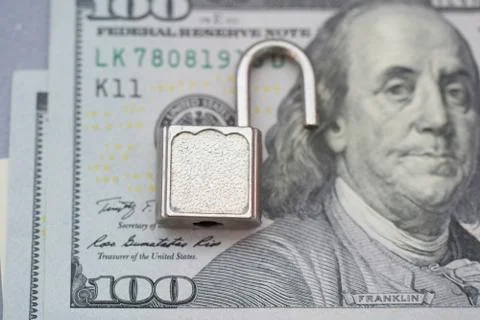 Opened security lock, open padlock on dollar bill background . Money protecti 스톡 사진