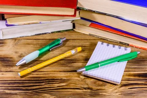 Opened small notepad and ball pens on a wooden table Stock Photos
