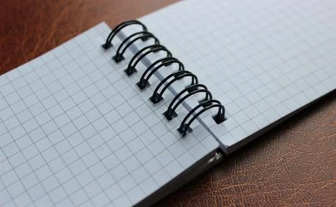 Opened spiral notebook on leather table detailed stock photo Foto stock