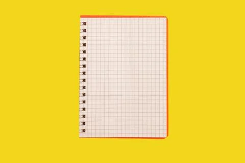 Opened spiral notebook on a yellow background Stock Photos