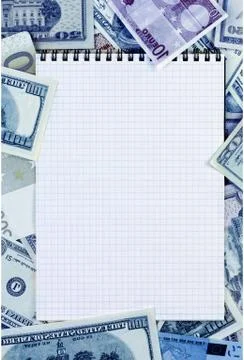 Opened spiral notepad on money background. stained blue Stock Photos