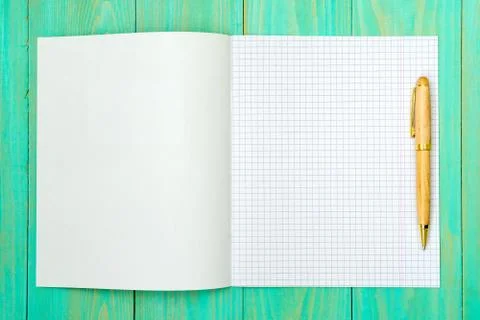 Opened squared school notebook with a pen Stock Photos