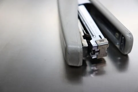 Opened stapler machine on the table Stock Photos