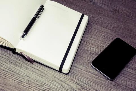 Opened white calendar or diary with pen and cellphone  Stock Photos