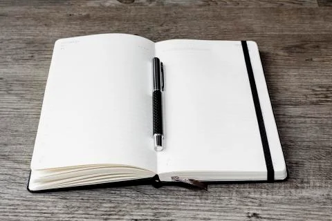 Opened white calendar or diary with pen  Stock Photos