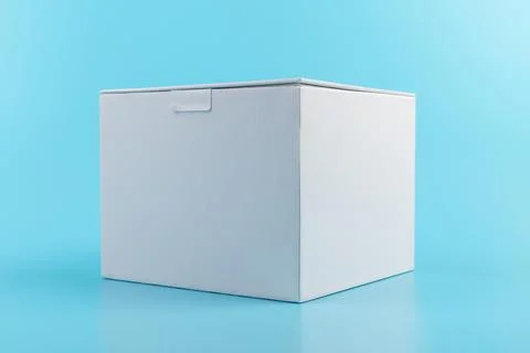 Opened white paper cube box on a blue background. Stock Photos