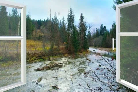 Opened window overlooking the river and mountains Stock Photos